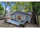 Wide angle of backyard, featuring a patio and the home's exterior with light blue siding and white trim at 1812 Defoor Nw Ave, Atlanta, GA 30318