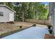 Backyard featuring a detached garage, wood fence, some foliage, and a small blue concrete patio at 1812 Defoor Nw Ave, Atlanta, GA 30318