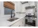 Modern kitchen with stainless steel appliances, white cabinetry, and a black faucet at 1812 Defoor Nw Ave, Atlanta, GA 30318