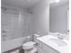 Bright bathroom with a shower-tub combo, white vanity and a large mirror at 2797 Malton Way, Loganville, GA 30052