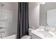 Bathroom featuring a tub and shower combo, white sink vanity, and a gray shower curtain at 2797 Malton Way, Loganville, GA 30052