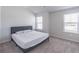 Bright bedroom featuring plush carpet, a bed, and natural light from multiple windows at 2797 Malton Way, Loganville, GA 30052