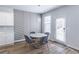 Cozy dining area features a modern table with seating for four, custom wall, and access to the backyard at 2797 Malton Way, Loganville, GA 30052