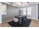 Modern dining room featuring a unique accent wall, designer lighting, and stylish furniture at 2797 Malton Way, Loganville, GA 30052