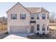 Beautiful two-story brick home featuring a 2-car garage and manicured front lawn at 2797 Malton Way, Loganville, GA 30052