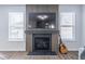 Living room fireplace with decorative wood paneling, flat screen TV, and a dark hearth at 2797 Malton Way, Loganville, GA 30052