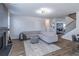 Inviting living room with a comfortable gray sectional sofa and modern decor and an inviting fireplace at 2797 Malton Way, Loganville, GA 30052