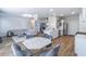 Open-concept living area features modern furnishings, wood floors, and an adjacent kitchen and dining area at 2797 Malton Way, Loganville, GA 30052