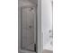 Elegant shower featuring marble tiling, glass doors, and modern fixtures at 2797 Malton Way, Loganville, GA 30052