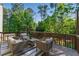 Cozy back deck offers outdoor seating for entertaining and relaxation surrounded by lush greenery at 3990 Old Spring House Ct, Atlanta, GA 30338