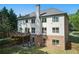 Back exterior of a two-story home, featuring a deck and a patio with outdoor seating at 3990 Old Spring House Ct, Atlanta, GA 30338