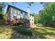 Expansive backyard view, showing the deck, lush greenery, and privacy fencing at 3990 Old Spring House Ct, Atlanta, GA 30338