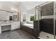 Bright bathroom featuring a soaking tub under a window and a tiled glass shower at 3990 Old Spring House Ct, Atlanta, GA 30338