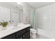 Neutral-colored bathroom with a combined shower and tub and vanity with dark wood cabinets at 3990 Old Spring House Ct, Atlanta, GA 30338