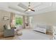 Neutral Bedroom featuring a comfortable chair, crib, and natural light at 3990 Old Spring House Ct, Atlanta, GA 30338