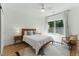 Serene bedroom featuring a cozy bed, shiplap wall, and natural light from the large window at 3990 Old Spring House Ct, Atlanta, GA 30338