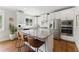Modern kitchen featuring stainless steel appliances, granite countertops, and a kitchen island with seating at 3990 Old Spring House Ct, Atlanta, GA 30338