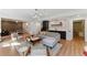 Spacious living room with a chic wet bar, modern lighting, and adjacent game area at 3990 Old Spring House Ct, Atlanta, GA 30338