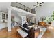 Open-concept living room with a grand piano, hardwood floors, and ample natural light, ideal for modern living at 3990 Old Spring House Ct, Atlanta, GA 30338