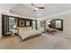 Elegant main bedroom features a tray ceiling, sitting area, and large windows for plenty of natural light at 3990 Old Spring House Ct, Atlanta, GA 30338