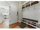 Mudroom featuring built-in storage shelves, bench seating, and organization for shoes and accessories with easy kitchen access at 3990 Old Spring House Ct, Atlanta, GA 30338