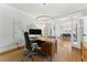 Bright office featuring an ample desk, a world map, and open doorway to other rooms at 3990 Old Spring House Ct, Atlanta, GA 30338