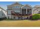 A Large backyard with gray siding, and a screened-in porch with a deck at 4425 Atwood Dr, Cumming, GA 30040