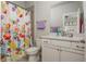 Well-lit bathroom featuring a floral shower curtain and a white vanity with countertop at 4425 Atwood Dr, Cumming, GA 30040