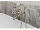 Close-up of a vintage style faucet for a modern soaking tub and decorative tile at 4425 Atwood Dr, Cumming, GA 30040