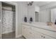 Bright bathroom featuring double sinks, white cabinets, and a shower with patterned curtain at 4425 Atwood Dr, Cumming, GA 30040
