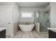 Modern bathroom features a freestanding tub and glass-enclosed shower with decorative tiling at 4425 Atwood Dr, Cumming, GA 30040