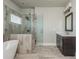 Bathroom featuring a shower with glass door, a soaking tub and a vanity sink at 4425 Atwood Dr, Cumming, GA 30040