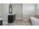 Bathroom featuring a vanity sink, a soaking tub and a door at 4425 Atwood Dr, Cumming, GA 30040