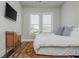 Comfortable bedroom featuring a large bed, natural light, and minimalist decor for a cozy and inviting space at 4425 Atwood Dr, Cumming, GA 30040