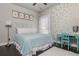 Charming bedroom with gold polka dot wall, light blue bedding, and matching desk and chair at 4425 Atwood Dr, Cumming, GA 30040