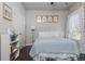 Comfortable bedroom with light blue bedding, white headboard, and gold framed art at 4425 Atwood Dr, Cumming, GA 30040
