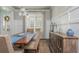 Beautiful dining room with a dark wood table, paneled walls, and natural light from the window at 4425 Atwood Dr, Cumming, GA 30040
