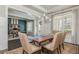 Open-concept dining and office space with a large wood table, paneled walls, and natural light at 4425 Atwood Dr, Cumming, GA 30040