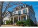 Beautiful two-story home with dormer windows, manicured bushes, and a covered front porch at 4425 Atwood Dr, Cumming, GA 30040