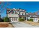 Charming two-story home boasts a two-car garage, well-manicured lawn and a welcoming entrance at 4425 Atwood Dr, Cumming, GA 30040