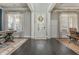 Inviting foyer with hardwood floors, wainscoting, and decorative wreath on front door at 4425 Atwood Dr, Cumming, GA 30040