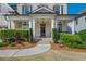 Inviting front porch with brick steps, and decorative wreath hanging on the front door at 4425 Atwood Dr, Cumming, GA 30040