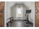 Bright home gym features a stationary bike and weight bench with natural light from a window at 4425 Atwood Dr, Cumming, GA 30040