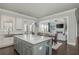 Gourmet kitchen with island, stainless steel sink, and gray and white cabinets at 4425 Atwood Dr, Cumming, GA 30040