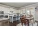 Spacious kitchen featuring white cabinets, stainless appliances, and connected dining area at 4425 Atwood Dr, Cumming, GA 30040