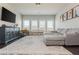 Spacious living room with a large gray sectional sofa and a stylish patterned rug at 4425 Atwood Dr, Cumming, GA 30040