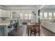 Open living space with kitchen, dining area, and large windows to outdoor deck at 4425 Atwood Dr, Cumming, GA 30040