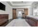 Spacious main bedroom with tray ceilings, a sliding barn door and ample natural light at 4425 Atwood Dr, Cumming, GA 30040