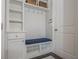 Mudroom features a bench with storage, hooks, white cabinets and coat closet at 4425 Atwood Dr, Cumming, GA 30040