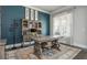 Well-appointed home office featuring stylish blue accent wall, custom built-ins, and a large decorative area rug at 4425 Atwood Dr, Cumming, GA 30040